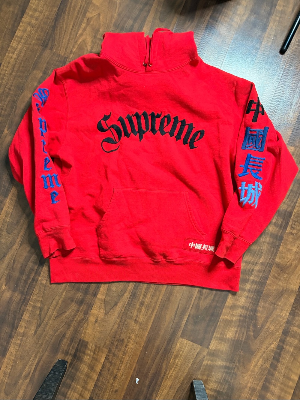 Supreme Red Crewneck with Black Chest Logo and Blue Sleeve Graphics